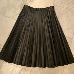 A stunning black faux leather pleated skirt from jcrew.